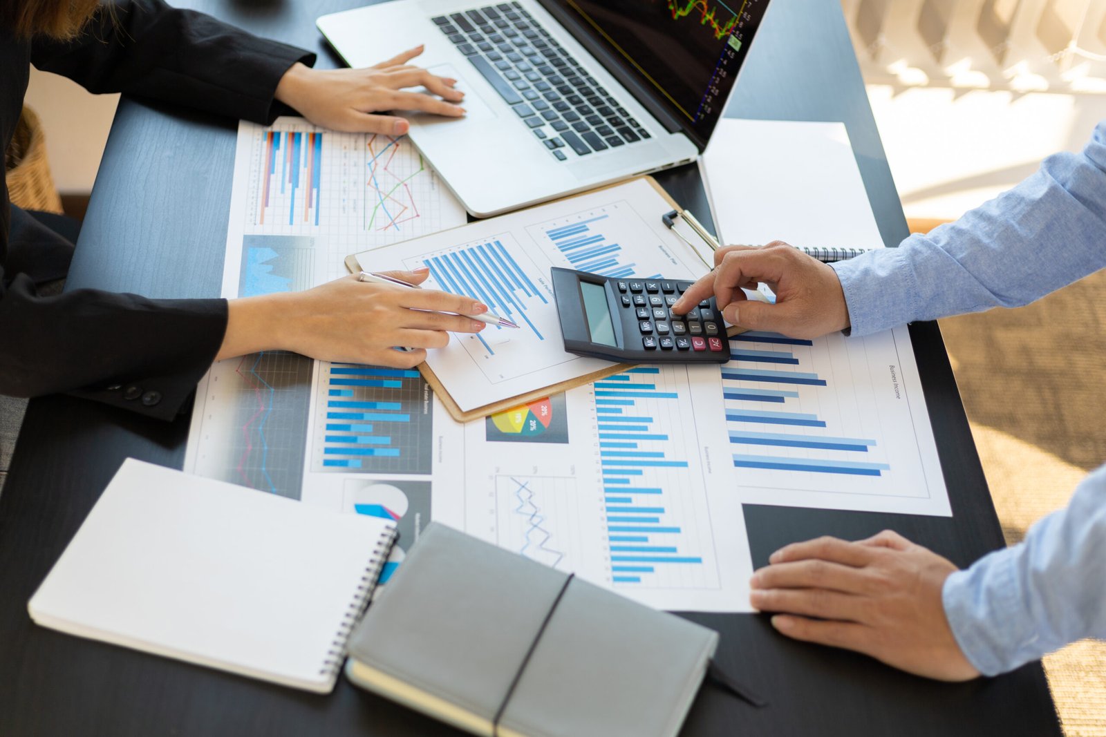 business-people-calculations-about-charts-and-grap-2026-01-09-01-13-01-utc